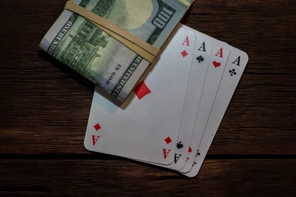 Beautiful image of four aces and a bundle of money on a wooden — Stock Photo, Image