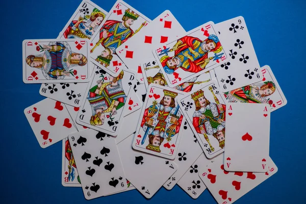 Playing cards in a random order on a blue background. Can be use