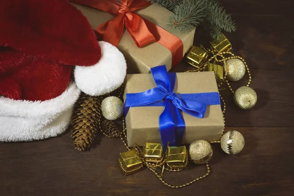 Santa Claus hat, boxes with gifts packed, spruce twig, golden be