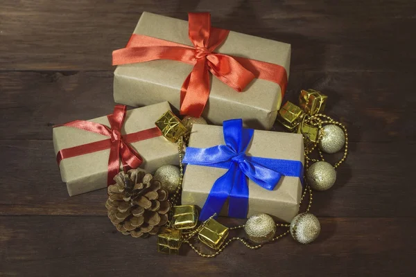 Packed gifts wrapped in kraft paper and bandaged with ribbons, d