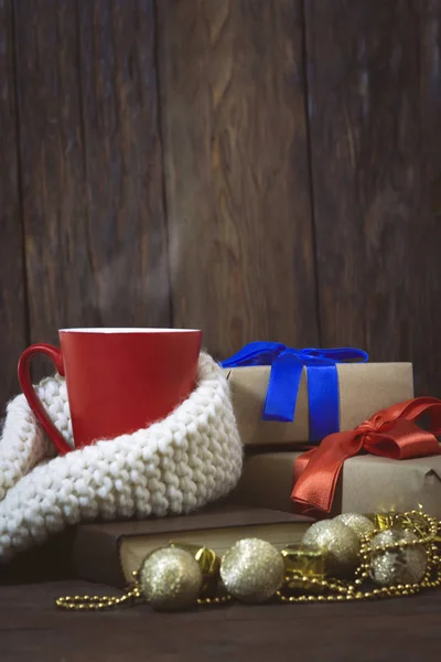 Red cup, scarf, book, packed gifts of red and blue ribbons, gold