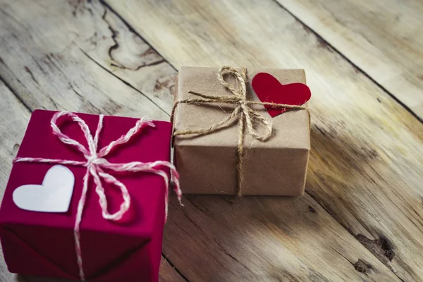 Two gift boxes and hearts. Wooden background — Stock Photo, Image