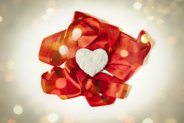 Red tape and white heart hand on white background. Bokeh — Stock Photo, Image