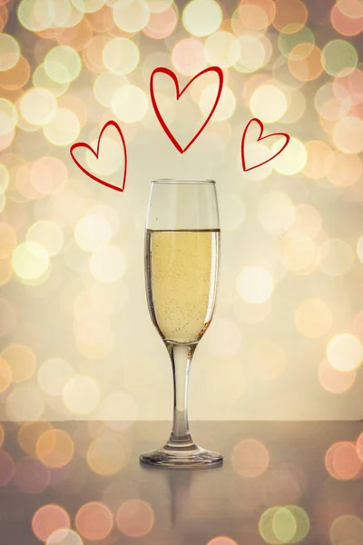 Glas med champagne och hjärtan. Mångfärgade bokeh — Stockfoto
