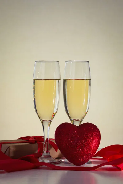 �� Packaged gift, two glasses with champagne and heart