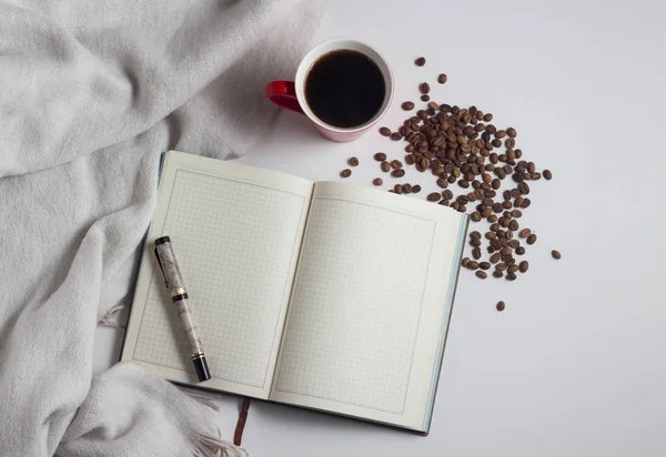 White Scarf, Diary, pen, red cup with coffee and grains of coffe