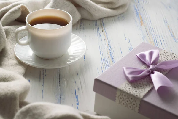Cup with Coffee, Gift on the White Wooden Table. Concept of Spri