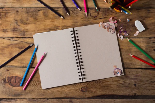 top view of a sketchbook with colored pencils arranged around on white  background Stock Photo by stoockking