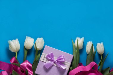 Lale, hediye ve pembe kurdele mavi zemin üzerine beyaz. Conce