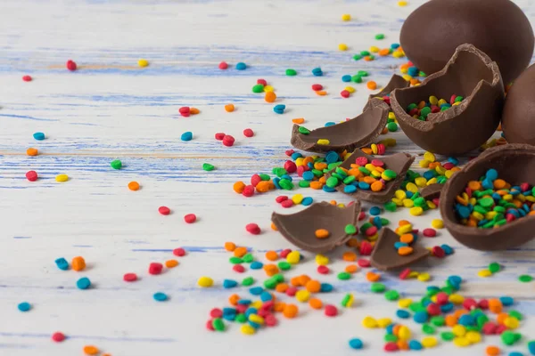 Easter Chocolate Eggs, Multicolored Sweets on the Old White Wood