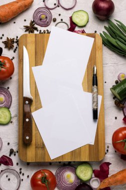 Bir kesme tahtası, kalem, bıçak co ile etrafında taze çiftlik sebze