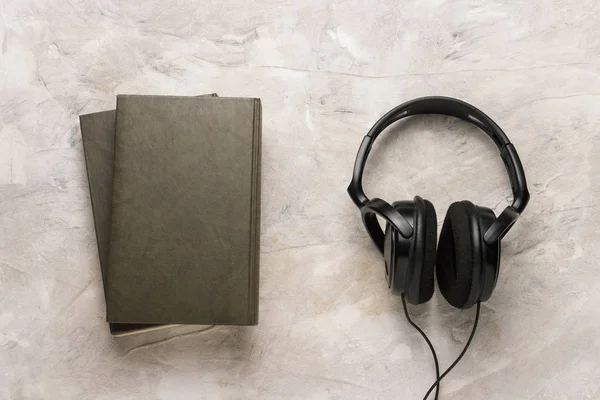 Twee boeken en koptelefoon op een witte achtergrond van de stenen. Concept Au — Stockfoto