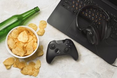 Dizüstü bilgisayar, Gamepad, kulaklık, patates cipsi, şişe bira bir l ile ilgili