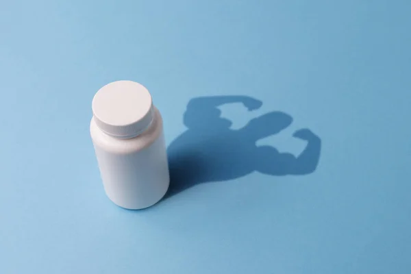 Plastikflasche mit Tabletten und der Schatten mit den Händen der — Stockfoto