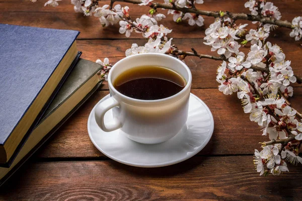 Sakura branches with flowers, White cup with Black Coffee and tw — Stock Photo, Image