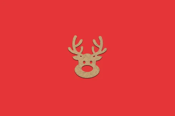 Wooden Christmas toy Deer head on a red isolated background. Mer