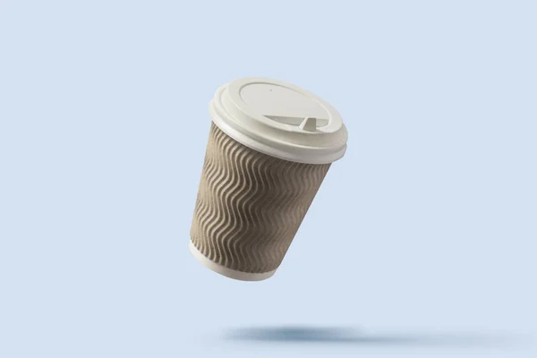 Paper cup with coffee flying in the air on a light blue background. Coffee shop concept. Levitation