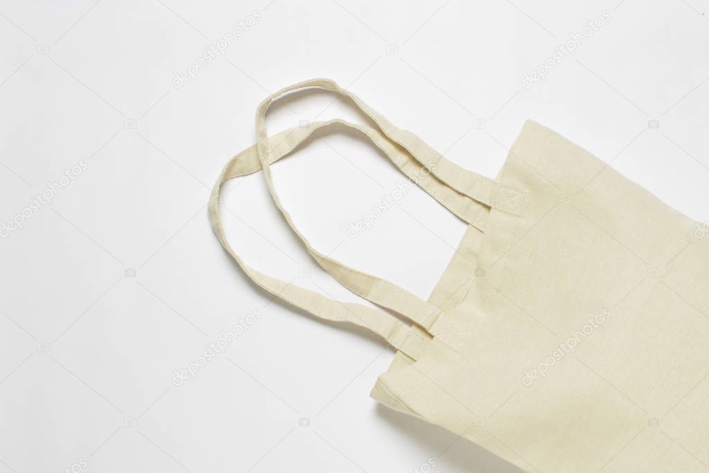 Bright linen bag for shopping on a white background. Eco material. Shopping concept, place for logo. Flat lay, top view