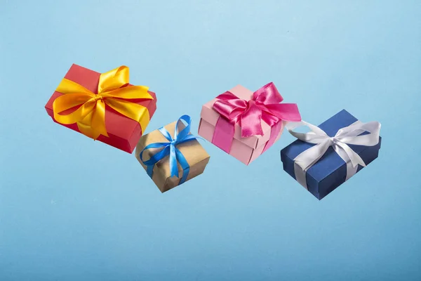 Gifts flying in the air on a blue background. Concept gift for a loved one, birthday, Valentine's Day. Levitation — Stockfoto