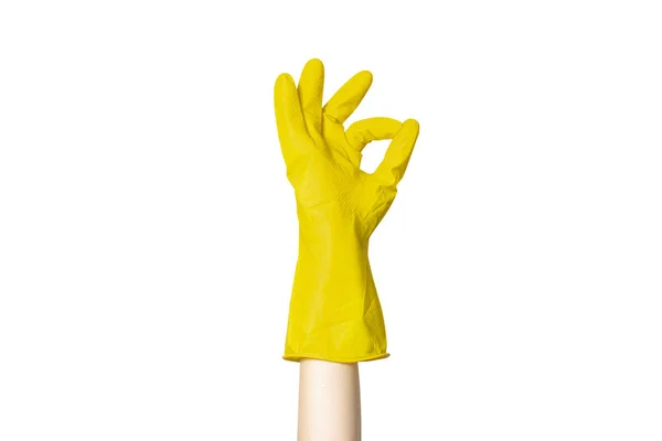 Female hand in a yellow rubber glove for cleaning shows a gesture on a white isolated background. All OK. High quality. Gesture done — Stock Photo, Image