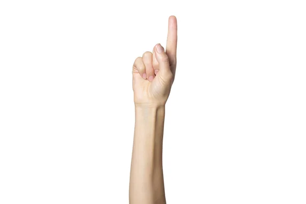 Die weibliche Hand zeigt eine Geste auf einem weißen, isolierten Hintergrund. Zeigefinger nach oben. Nummer eins — Stockfoto