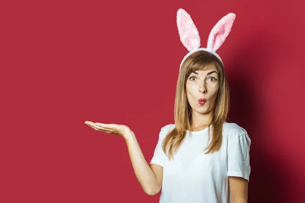 Young girl with rabbit ears on a pink background. Happy Easter Concept, Easter Bunny — Stock Photo, Image