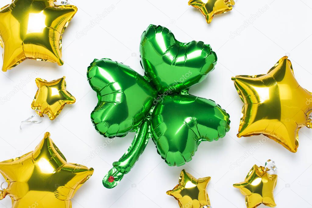 Balloon Clover and Air Golden balloons star shape on a white background. Concept holiday, party, ireland, st patricks day, luck. Banner Flat lay, top view