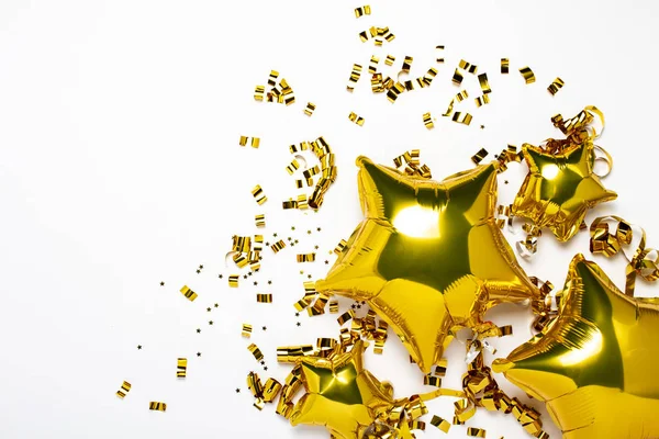 Aria palloncini d'oro stella e forma di coriandoli su uno sfondo bianco. Concetto di vacanza, festa, compleanno, decorazione. Banner Posa piatta, vista dall'alto — Foto Stock