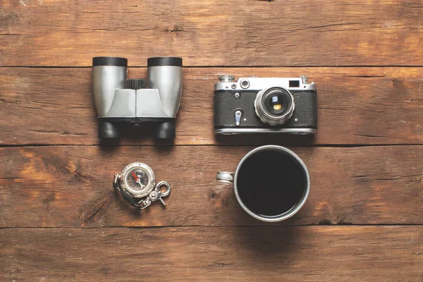 Binoculars Compass Camera Cup Tea Camping Equipment Wooden Background Concept — Stock Photo, Image