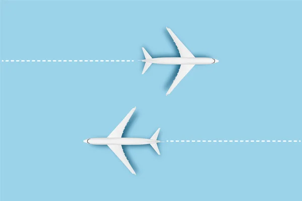 Two Airplanes and a line indicating the route on a blue background. Concept travel, airline tickets, flight, route pallet. Banner. Flat lay, top view.