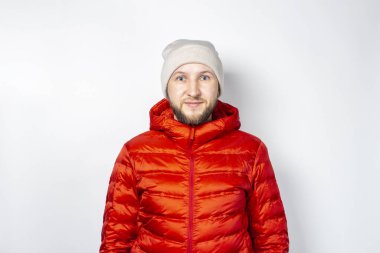 Kırmızı ceketli ve arka planda şapkası olan güzel bir genç adam. Sonbahar konsepti, kıyafetler, alışveriş.