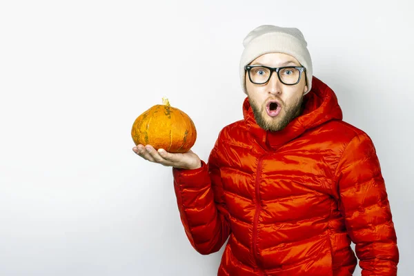 Scared Young Man Red Jacket Hat Holds Pumpkin Light Background — Stock Photo, Image