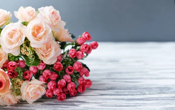 Buquê com flores rosa rosas em um fundo rural luz — Fotografia de Stock