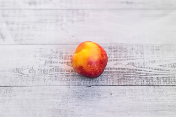 Ripe nectarine on an eco-friendly clean table