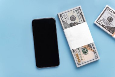 Metin, resim ve mavi arkaplan üzerine 50, 100 dolarlık banknotlar eklemek için boş ekranlı cep telefonu