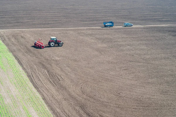 Tractor sows on the field — Stok Foto