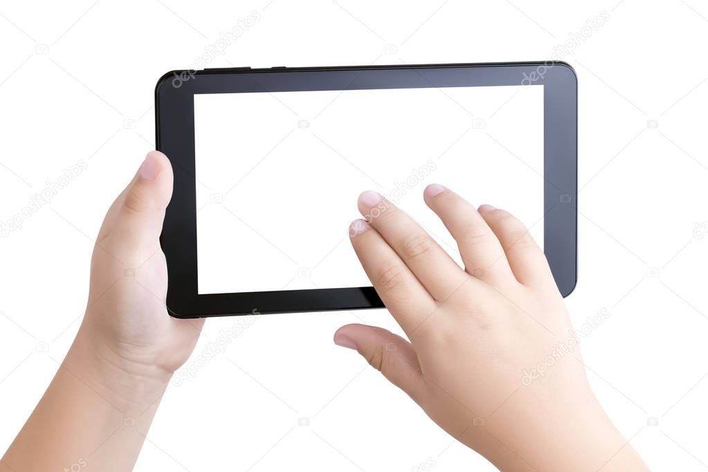 Top view closeup on the hands of a white child holding a black tablet PC with a white blank screen and scrolling the photos or Internet pages with his fingers. Child safety on the Internet. Mockup, te