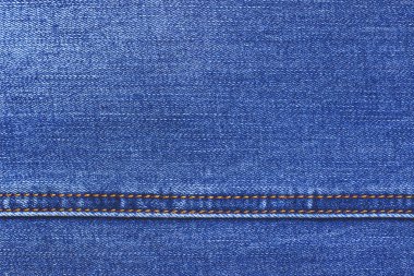 Dikişi bile güzel olan mavi bir kot pantolon manzarası. Sarı iplik dikişleri. Soyut modern moda dokusu arka planı. Metin için alanı kopyala.
