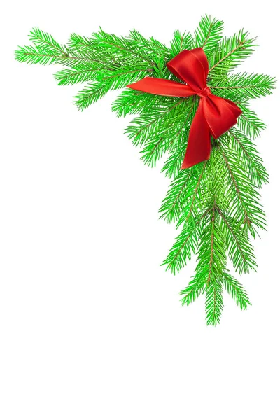 Red satin ribbon bow on green fluffy natural fir branches with copy space isolated on white background. Corner of Christmas tree branches. — Stock Photo, Image