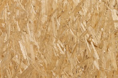 Tahta yonga tahtası dümdüz yatıyordu. Yatay ahşap doku. Osb odaklı iplik tahtası. Soyut dikişsiz ahşap arkaplan.