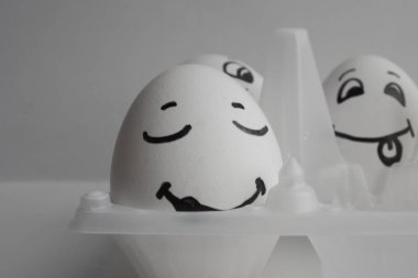 Eggs funny with faces Concept sleep among noise clipart