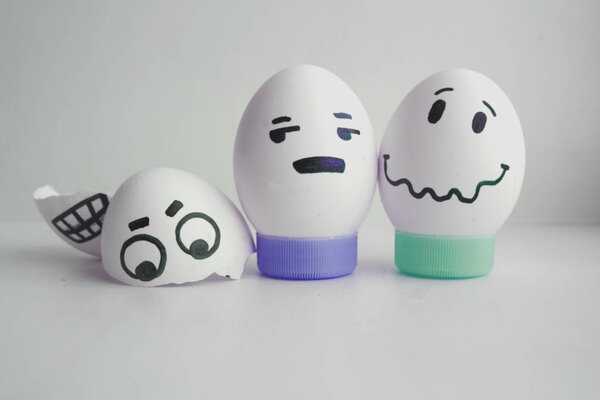 Cheerful eggs with two face concept warned