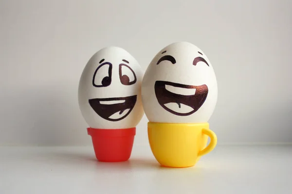 Eggs face. Cheerful breakfast company. Photo for your design