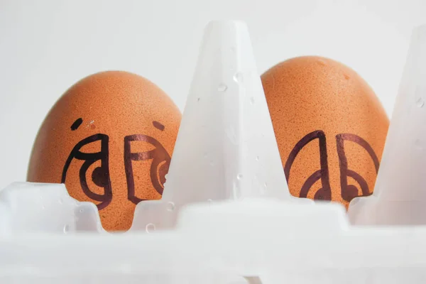 Eggs with painted face. Photo for your design.
