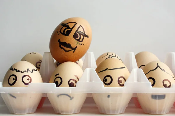 Eggs with a painted face in two rows
