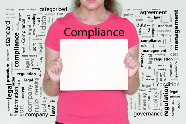 Compliance concept. girl in red holds — 图库照片
