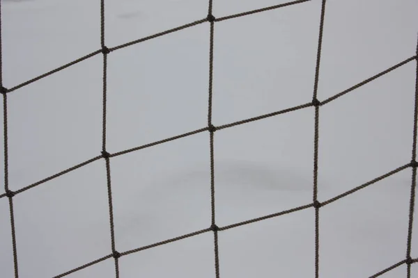 Grid of rope on the background of snow — Stock Photo, Image