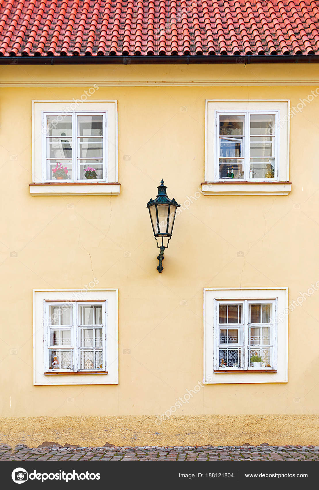 Facade Of The Yellow House With A Red Tiled Roof Stock Photo