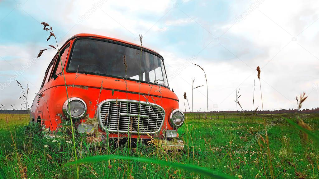 Russia, St. Petersburg, 21.07.2017 - Red car in the grass on the field. The car 60-ies. 