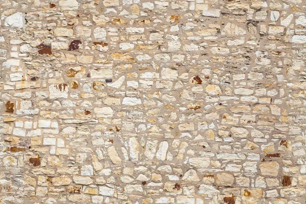 Seamless texture of old stone beige wall